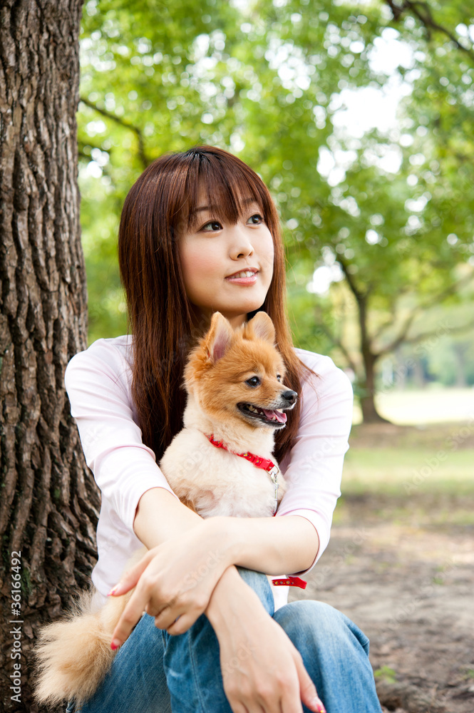 attractive asian woman with dog in the park attractive asian woman with dog in the park