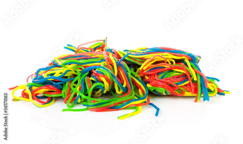 Pile of colorful fruit laces candy over white background