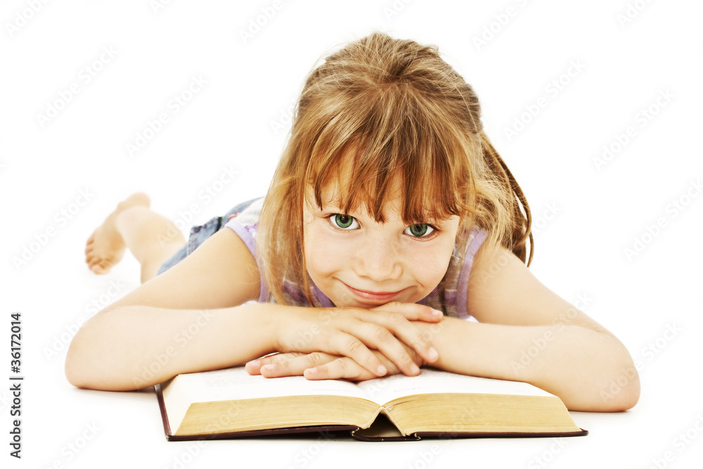 Little girl lieing on the floor and reading book Little girl lieing on the floor and reading book
