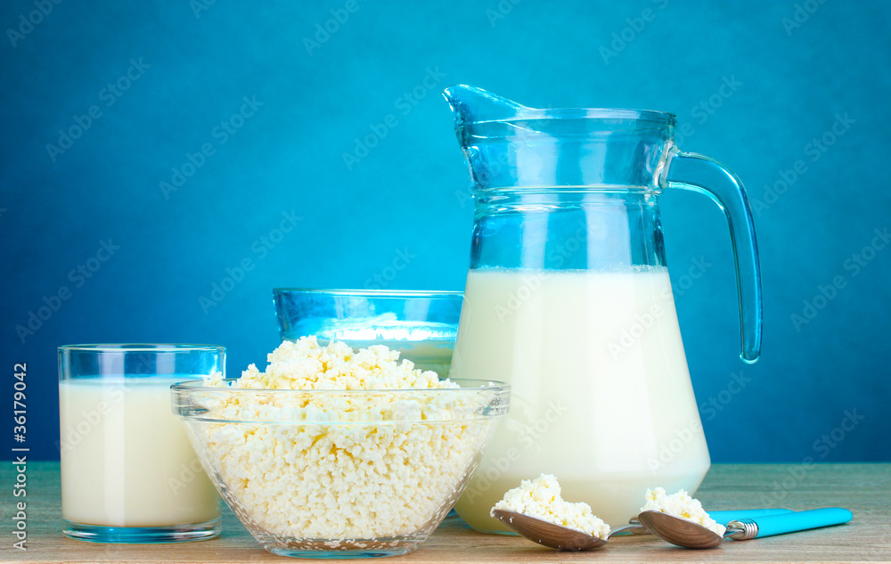 Dairy products on wooden table on blue background Dairy products on wooden table on blue background