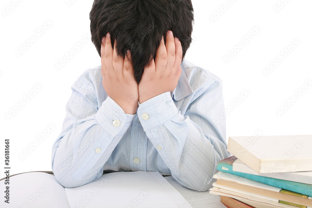 Schoolboy being stressed by his homework, isolated on white back Schoolboy being stressed by his homework, isolated on white back