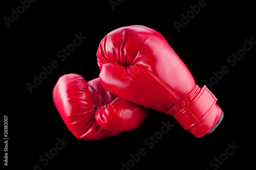 Red boxing gloves isolated on black © Elnur