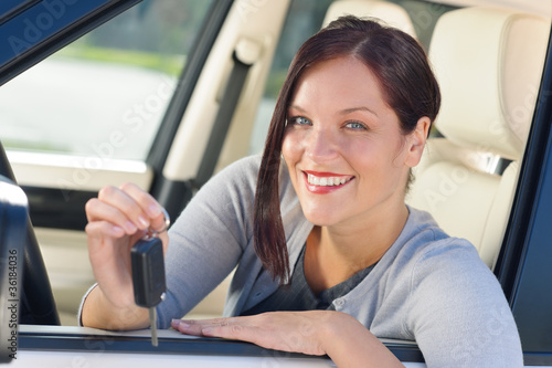 Attractive businesswoman in new car showing keys © CandyBox Images