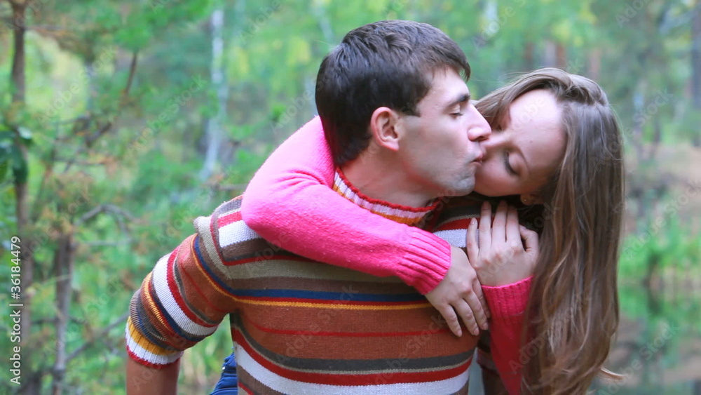 Girl jumping at her boyfriend and them kissing Girl jumping at her boyfriend and them kissing