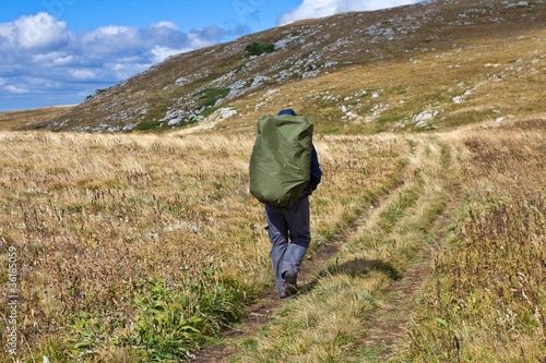 hiker walk by a mountain road