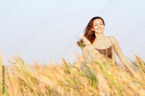young happy woman in yellow field