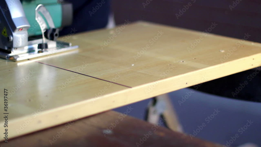 Home improvement - handyman sanding wooden floor in workshop Home improvement - handyman sanding wooden floor in workshop