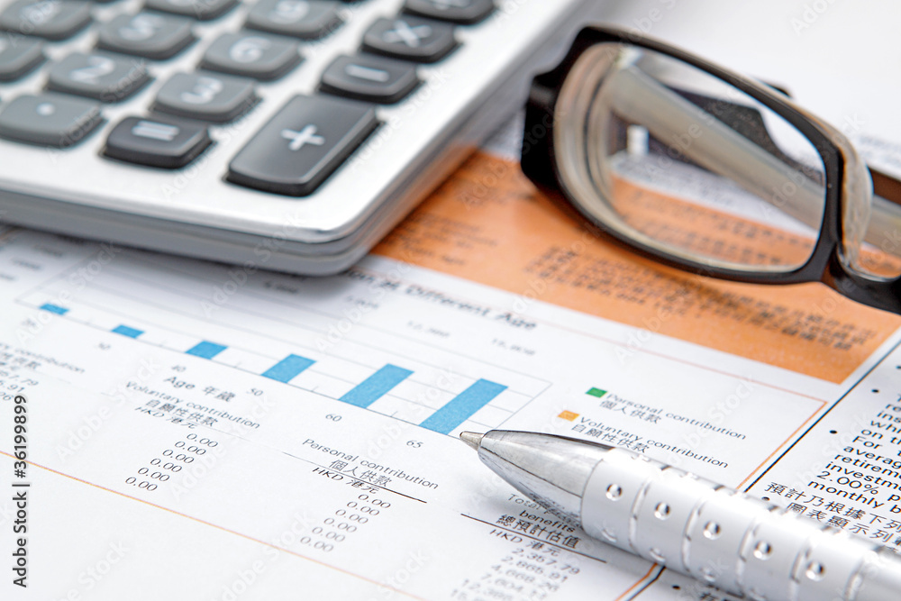 Stock chart with calculator,pen and eyeglasses Stock chart with calculator,pen and eyeglasses