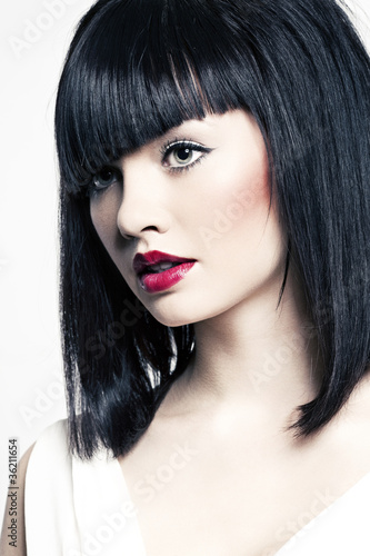 beautiful girl with perfect skin, red lipstick and black hair