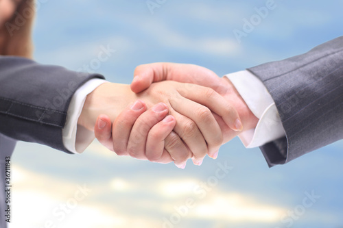 handshake in the blue sky