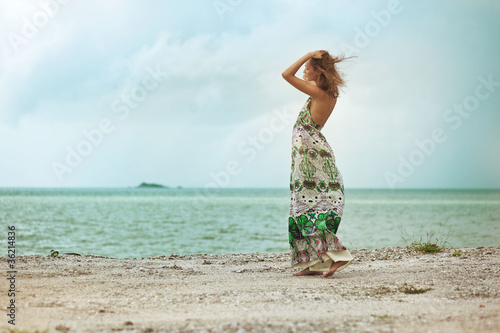 Woman walking on beach,  a sense of freedom