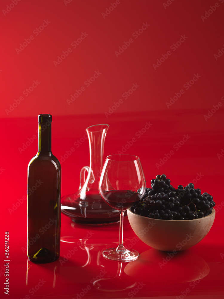 glass red wine, bottle, grapes and pitcher