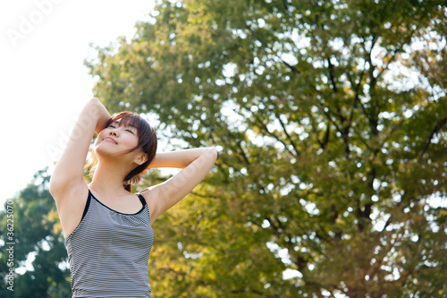 beautiful asian woman exercising in the park © taka