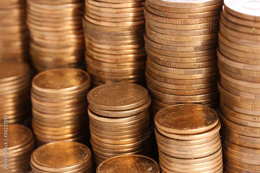 Many coins in columns isolated on white. Ukrainian coins