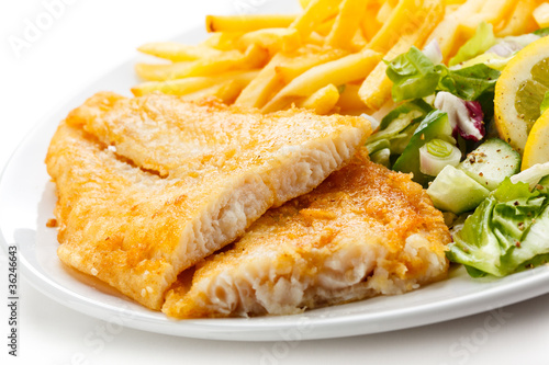 Fish dish - fried fish fillet, French fries with vegetables