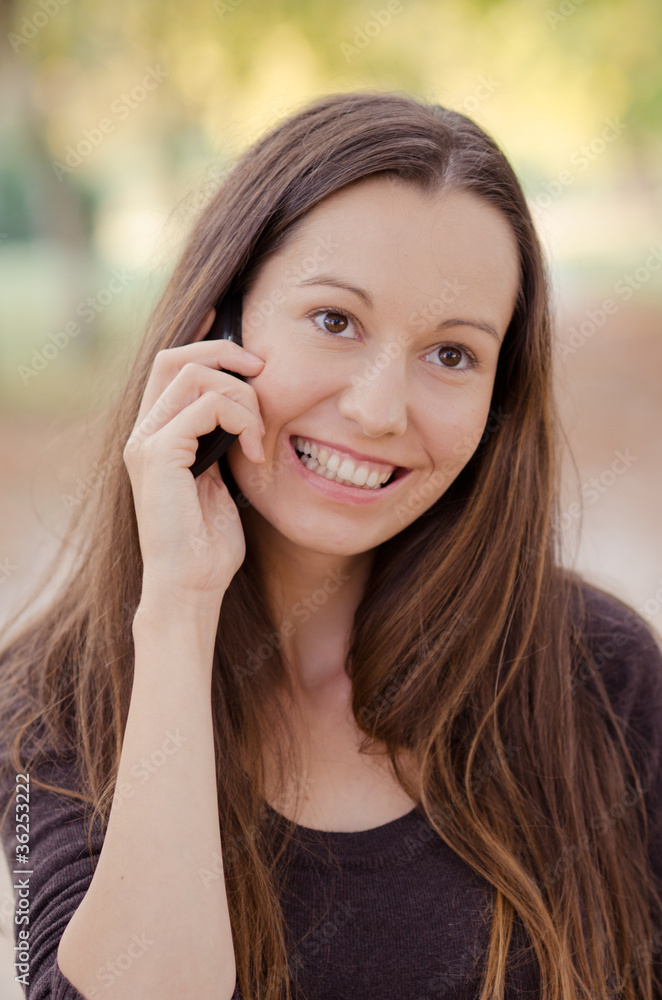 Beautiful smiling woman talking on cell phone