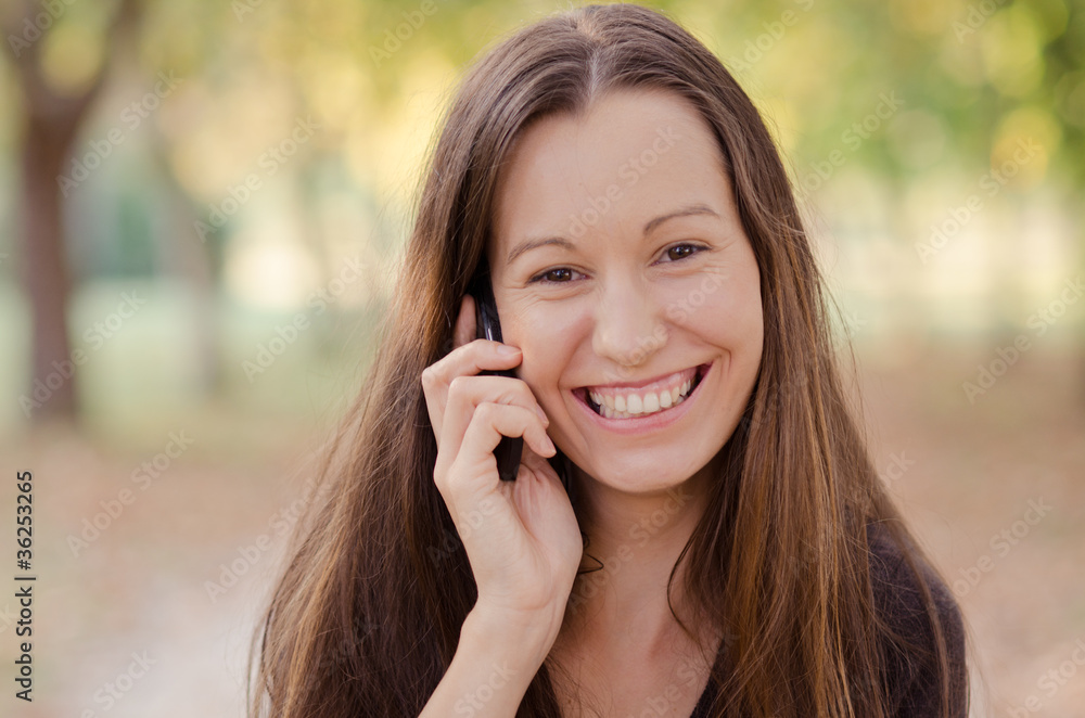 Happy young lady talking on mobile phone Happy young lady talking on mobile phone