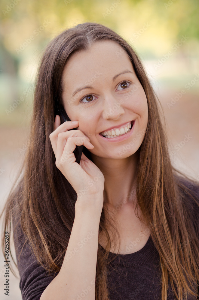 Portrait of a laughing young woman talking on phone Portrait of a laughing young woman talking on phone