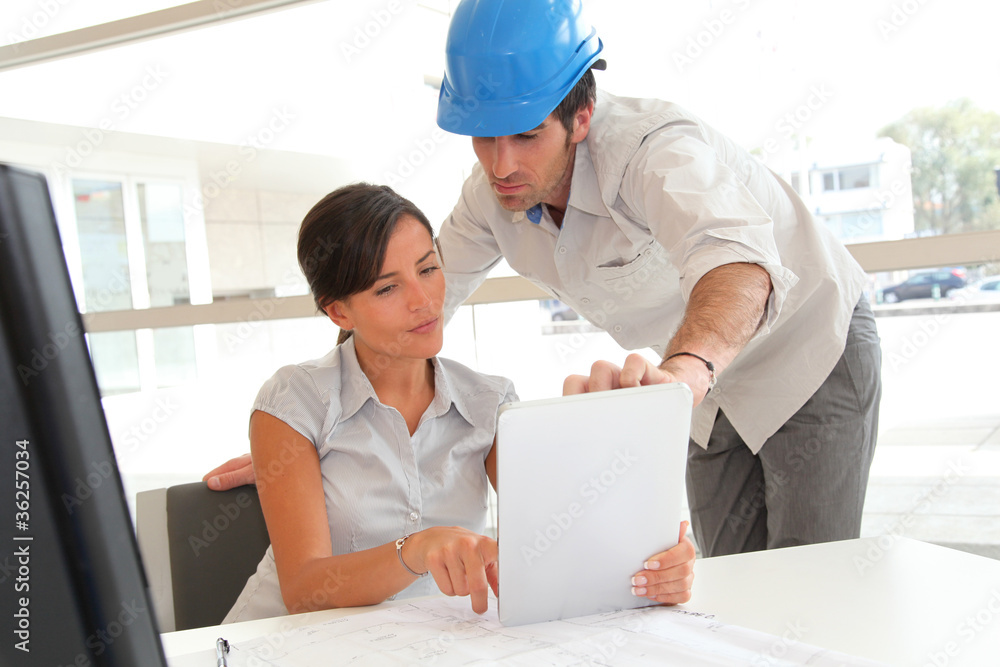 Architects working in office with electronic tablet Architects working in office with electronic tablet