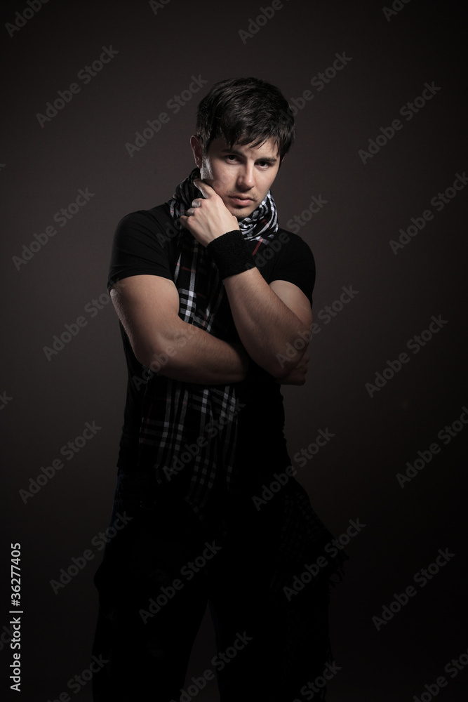 Young man. dark background.