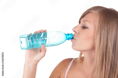 Thirsty young women drinking water after fitness workout