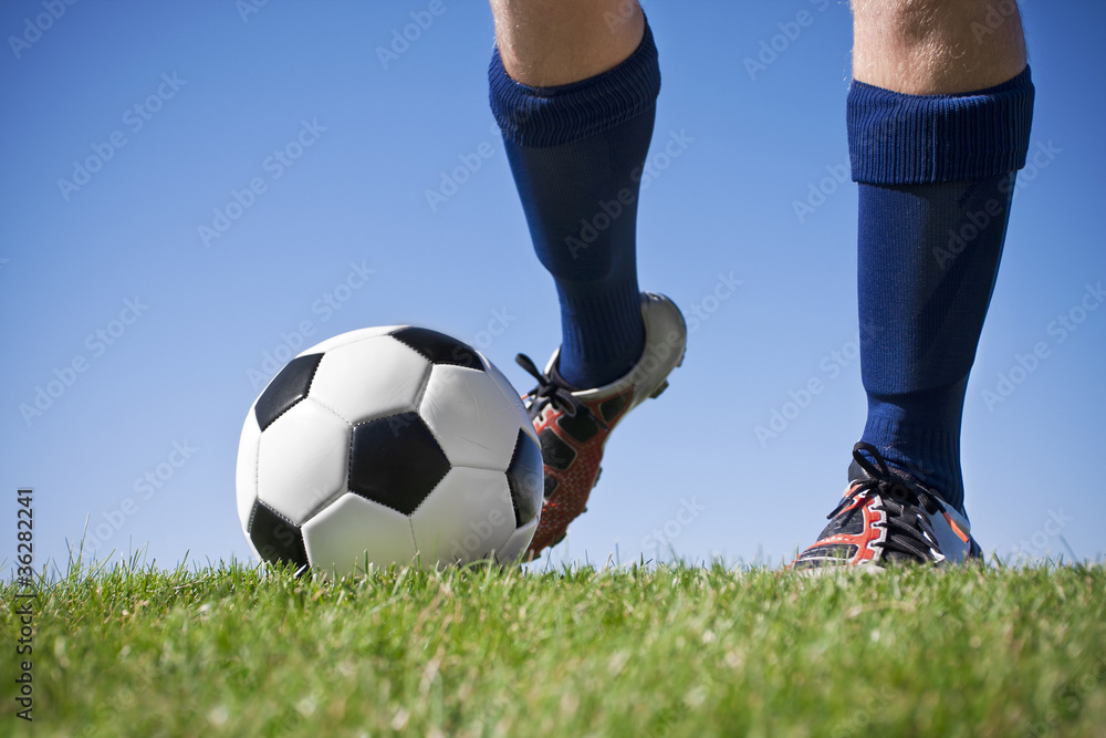 Fototapeta premium Kicking the soccer ball (close up view)