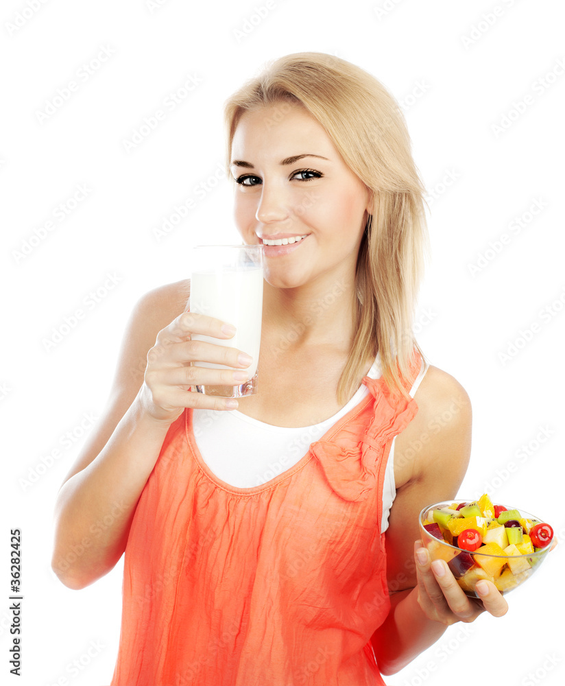 Pretty girl eating fruits and drinking milk Pretty girl eating fruits and drinking milk