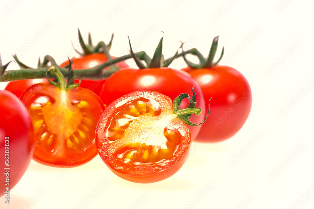 Sliced cherry tomato close up, isolated on white background Sliced cherry tomato close up, isolated on white background