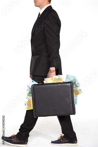 businessman carrying suitcase full of money photo