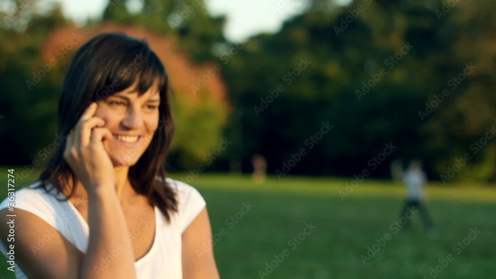 Woman talking on mobile phone outdoors Woman talking on mobile phone outdoors