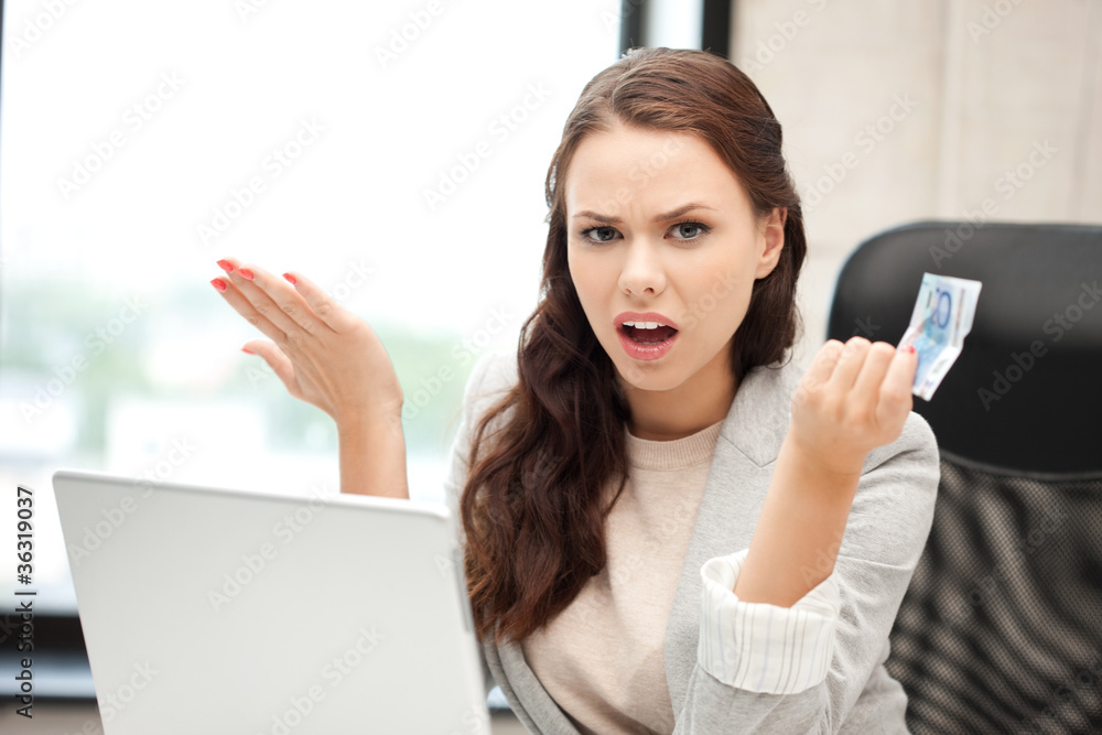 unhappy woman with computer and euro cash money unhappy woman with computer and euro cash money