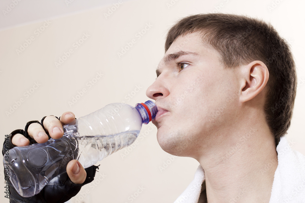 Sportsman drinks water from a plastic bottle Sportsman drinks water from a plastic bottle
