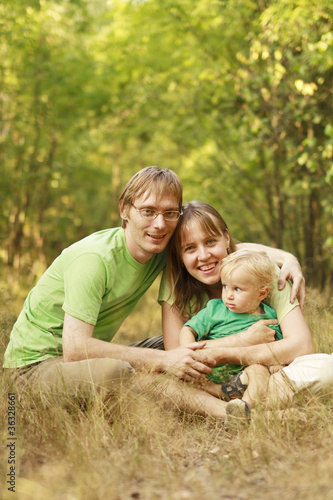 Happy family in summer forest