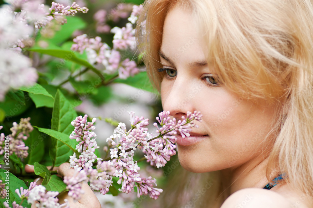 Woman with lilac flower on face