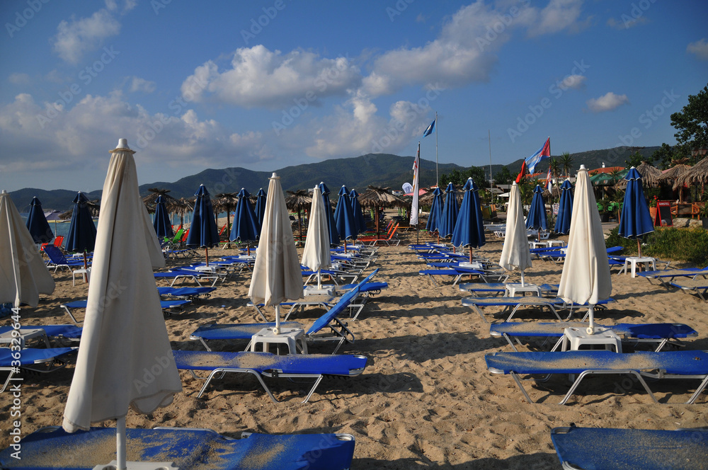 sandy beach with umbrellas and  loungers