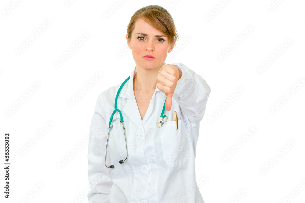 Serious medical doctor woman showing thumbs down Serious medical doctor woman showing thumbs down