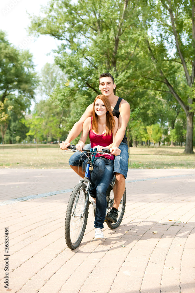 happy couple riding on a bicycle
