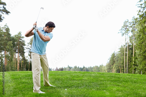 Mature man playing golf