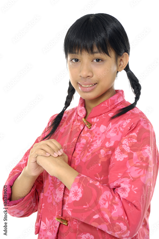 A young chinese girl is standing with a smile. A young chinese girl is standing with a smile.
