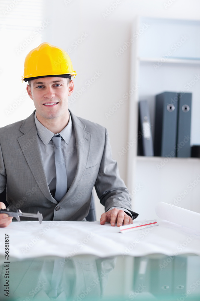 Close up of smiling architect working on a plan Close up of smiling architect working on a plan