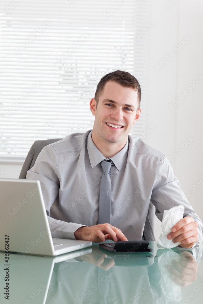 Happy businessman checking an invoice Happy businessman checking an invoice