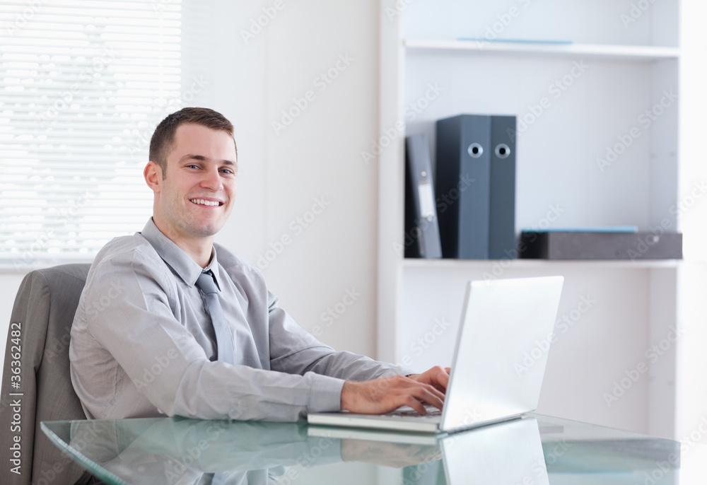 Satisfied businessman working on his laptop