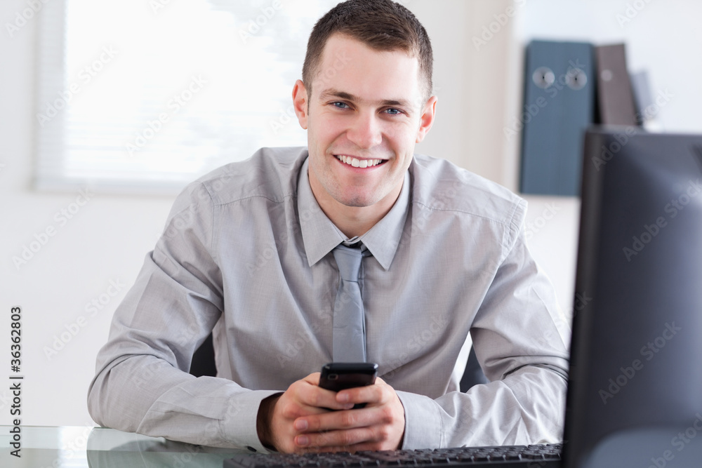 Businessman happy about a text message Businessman happy about a text message