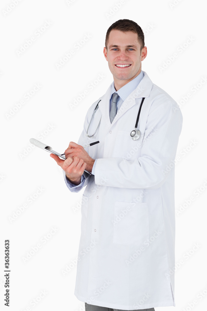 Smiling doctor taking notes