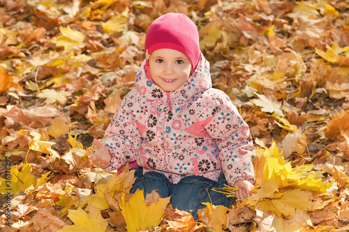 Little girl in the yellow leaves