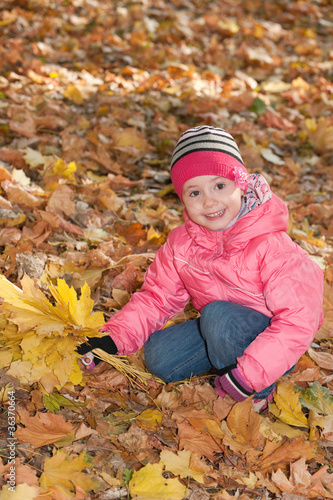 Little girl with yellow leaves