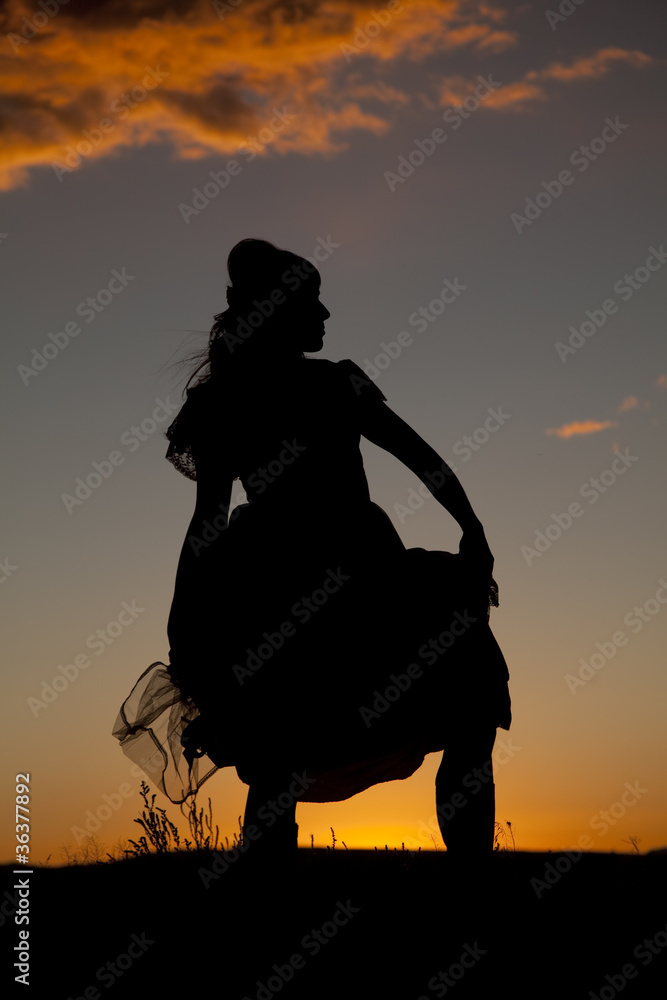 western woman hold dress silhouette