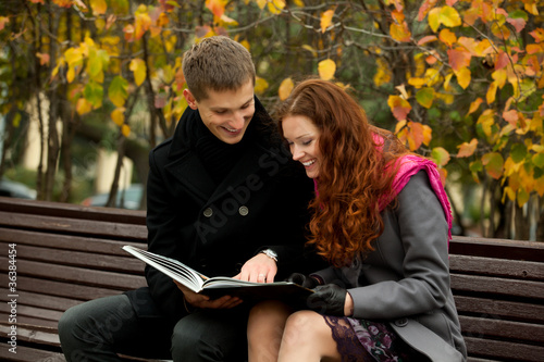 young couple is considering a book