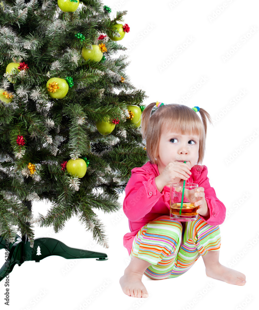 Beautiful girl drinking juice, background christmas tree Beautiful girl drinking juice, background christmas tree
