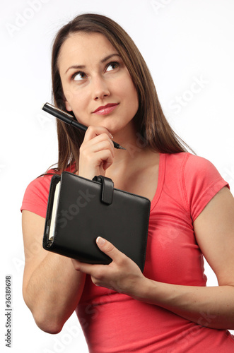 Fotografie Young woman holding a filofax